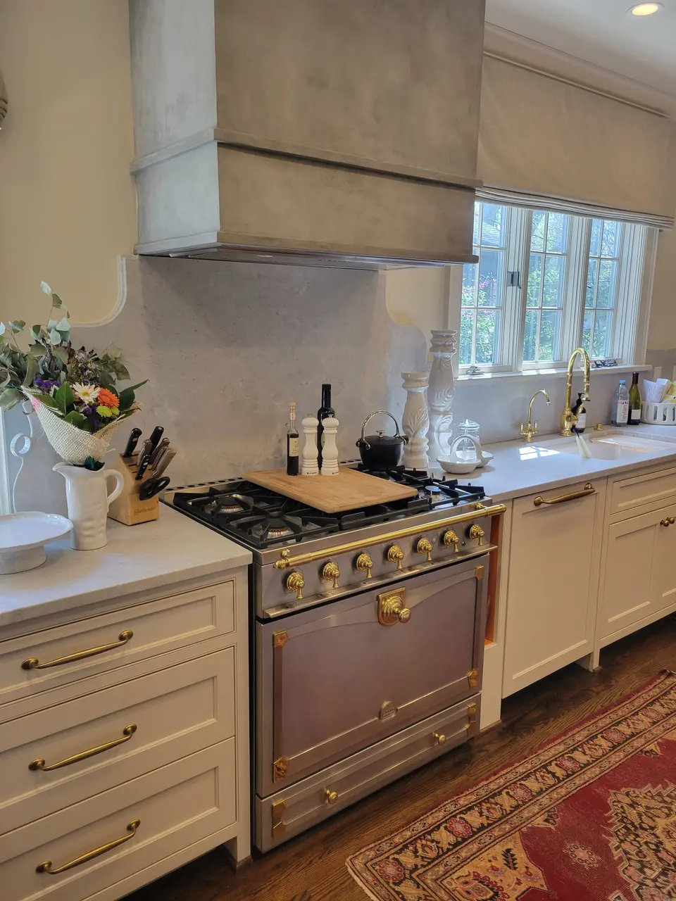 Custom kitchen with brass range by Keeler Carpentry